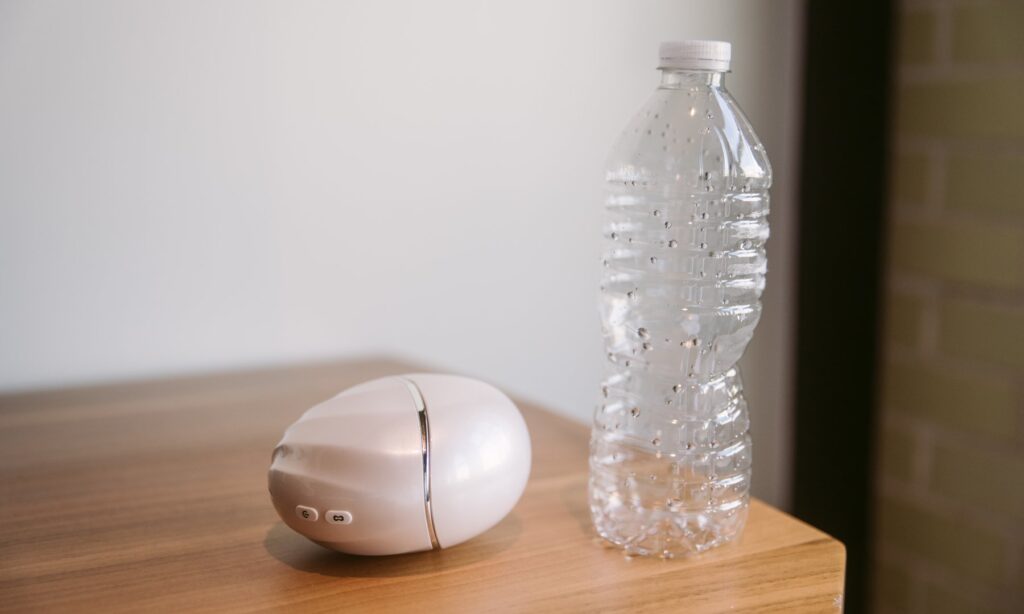 The Cloud Kiss next to a water bottle. It's wider than the water bottle but much smaller in height.