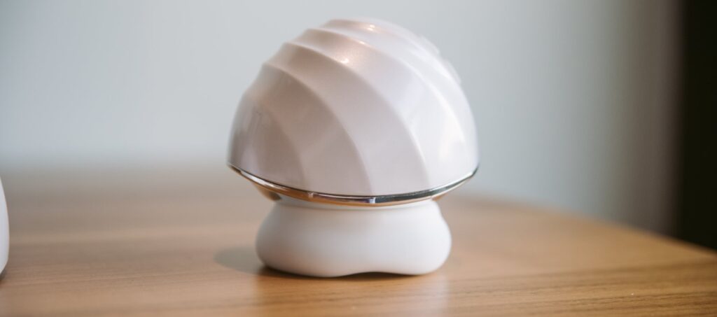 The "usable" end of the vibrator rests on the table, showcasing the dome-shaped opposite side. For my Joylume Cloud Kiss review.