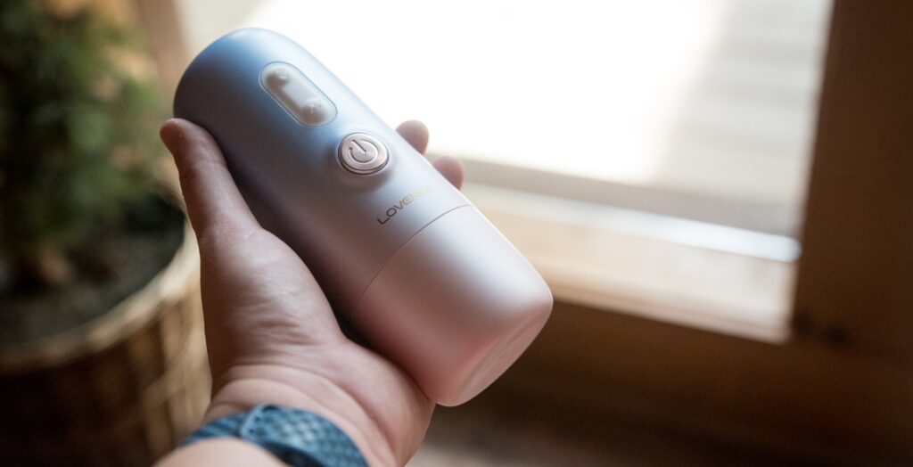 I hold the sex machine in one hand. It looks about the size of a tall can of soda.