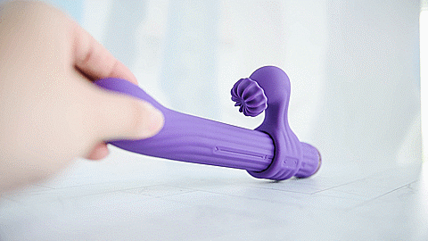 The buffing clitoral attachment shown rotating in circles when the toy is turned on. For my AVIDLOVE PLAY Four-Attachment Rabbit Vibrator review.