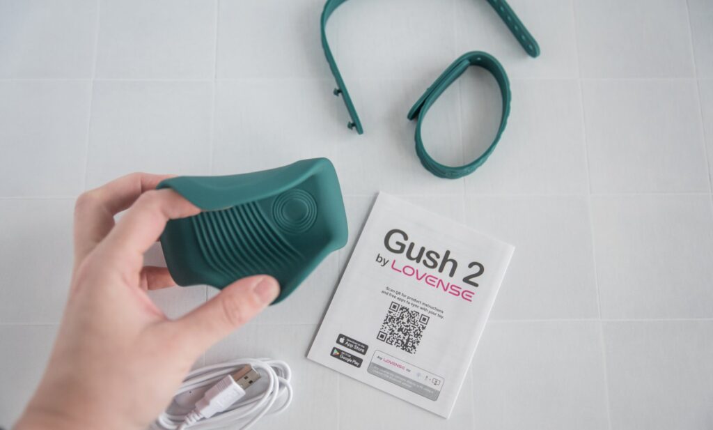 Everything included with the Gush 2. There's the vibrator itself, the instruction manual, the two hands-free bands, and the charging cord. For my Lovense Gush 2 review.