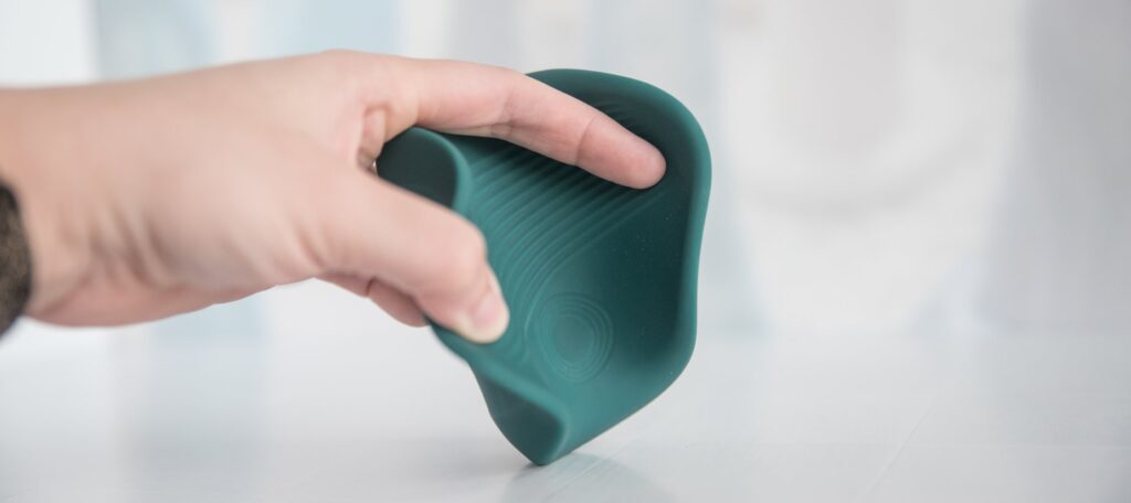 My fingers spread the Gush 2's sides open, showcasing the ribbing on the inside of the stroker to add pleasure.
