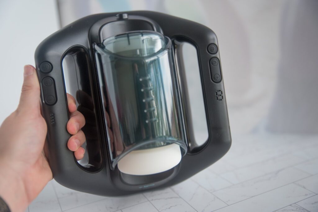 My hand holds the stroker to the camera. It looks pretty big, but my hand looks like it's comfortably holding it. The base of the Jetpack isn't flat; it's curved to easily sit between two thighs.