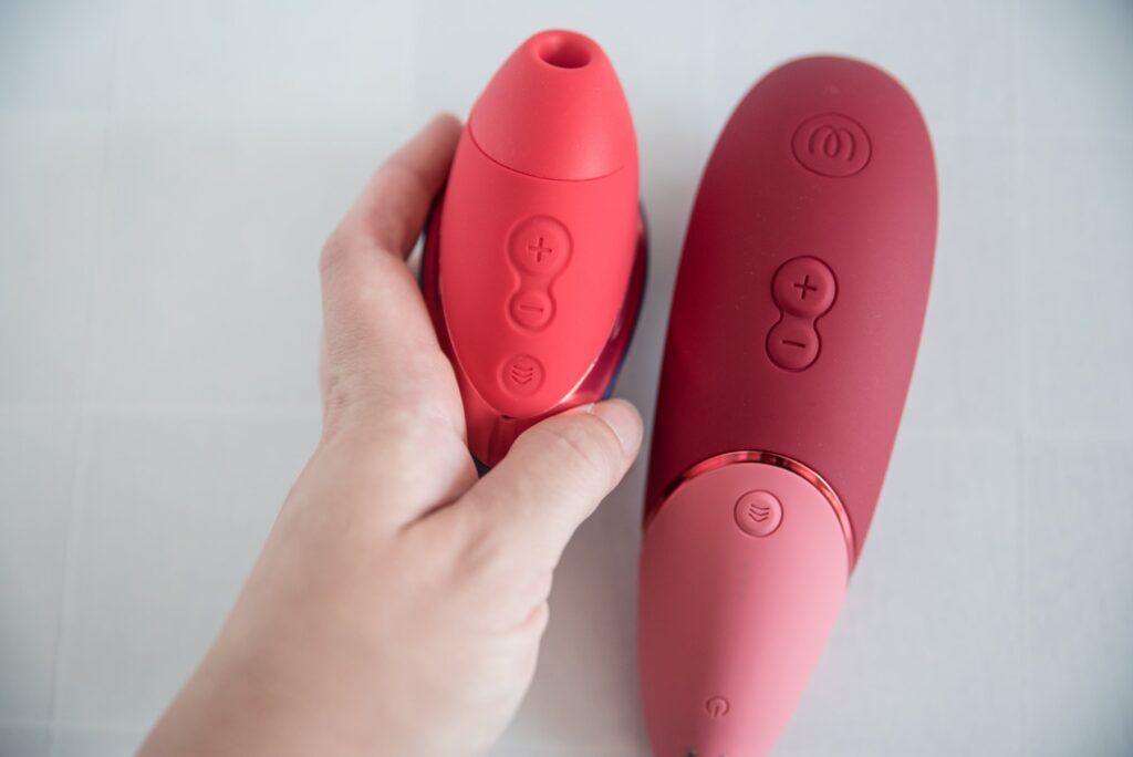 The two vibrators' control panels shown next to one another. They have extremely similar controls. Both have a Plus and Minus button, and both have a 3D control button. The Next Liberty lacks a dedicated power button, and the controls for the Next Liberty are on the same side as the air suction hole. For my Womanizer Next Liberty vs Womanizer Next comparison