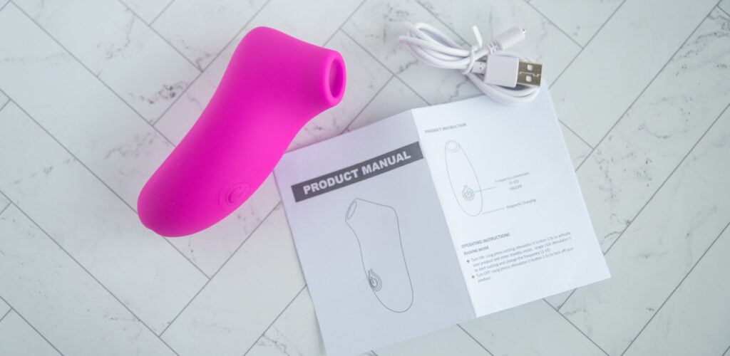 Everything that comes with the toy. There's the toy itself, the charging cable, and the instruction manual. For my AVIDLOVE PLAY Ergonomic Max Suction Clitoral Vibrator review.