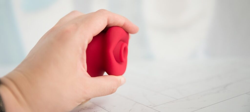 My hand holds the toy to the side, showcasing how wide the lips are in addition to the lack of protrusion of the toy's air suction hole compared to the lips themselves.