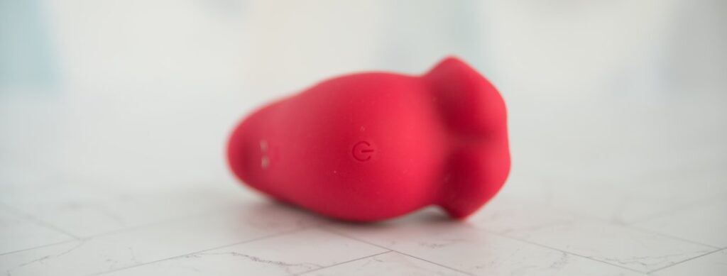 Top-down view of the vibrator shows the single button that controls all of the functions on the top side of the toy. For my AVIDLOVE PLAY Kiss Air Pulse Vibrator Review.
